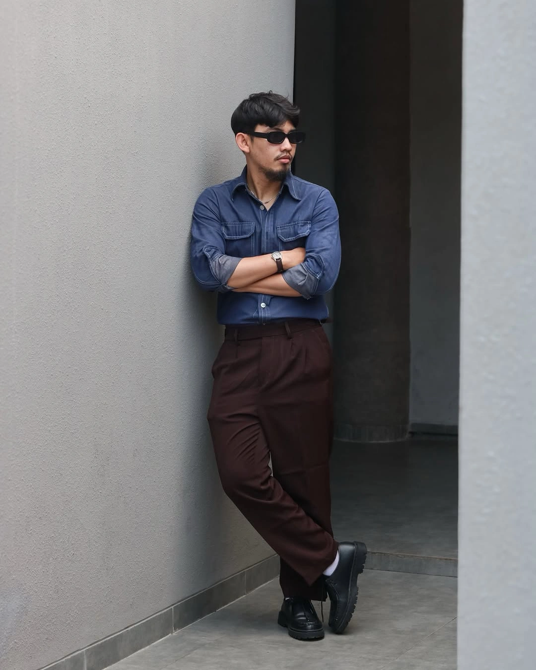 Blue button-up shirt with burgundy trousers and dark shoes