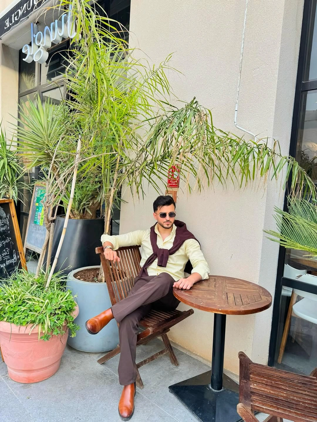 Cream long-sleeve top with burgundy knit and brown trousers