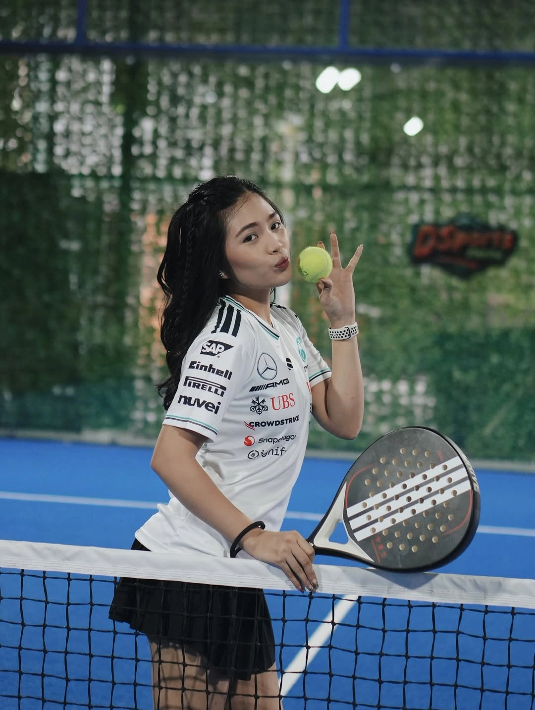 White graphic athletic shirt with black skirt for padel practice