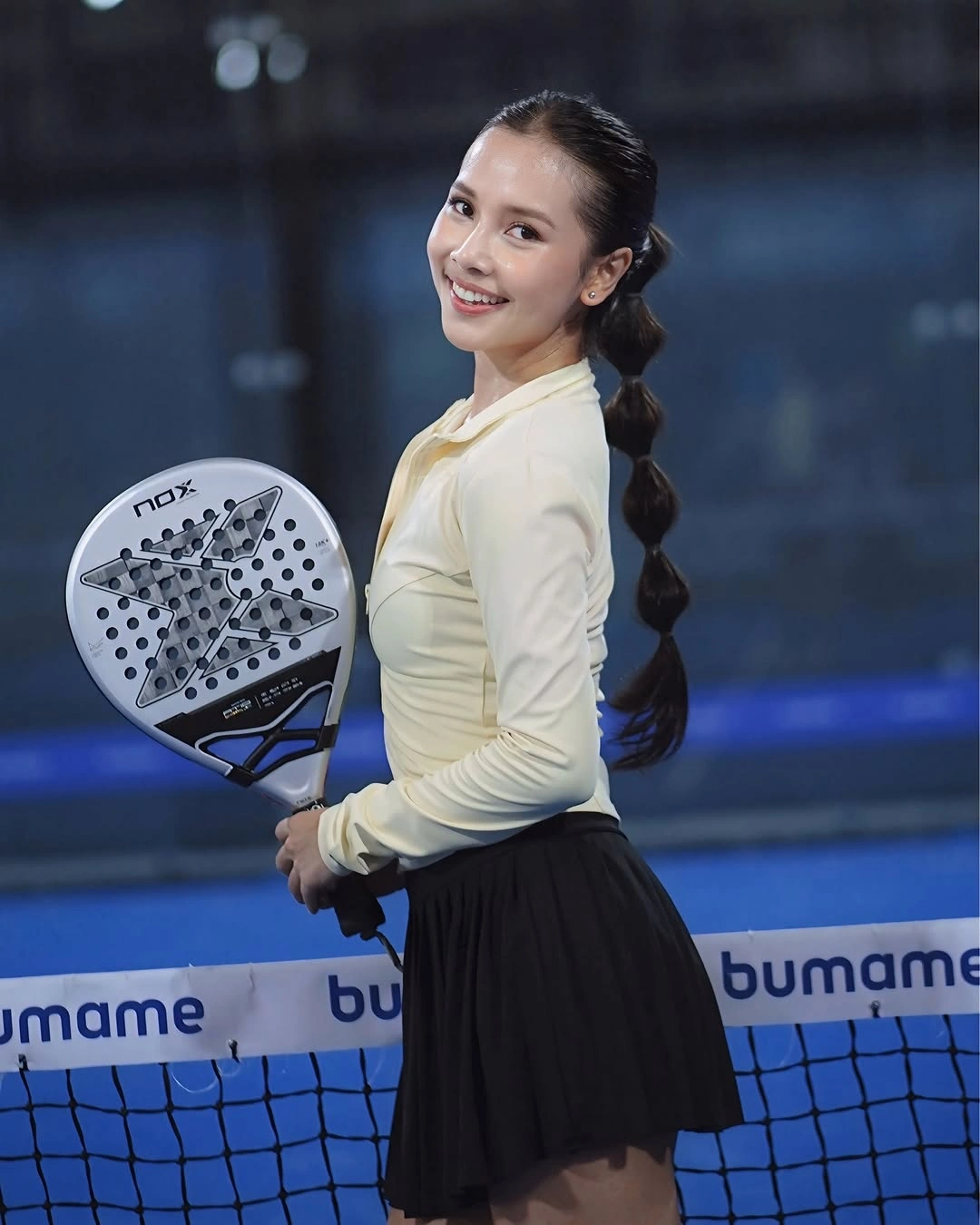 Cream zip top with black pleated skirt for padel