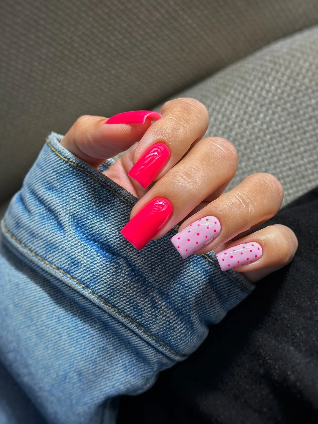 Long hot pink square nails with one pale pink dotted accent nail