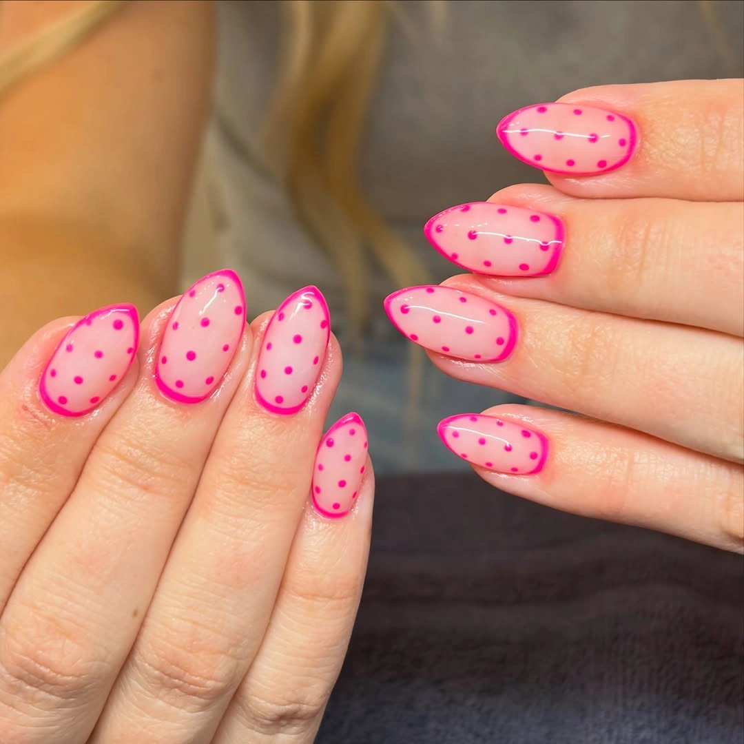 Medium almond bright pink nails with darker berry pink polka dots