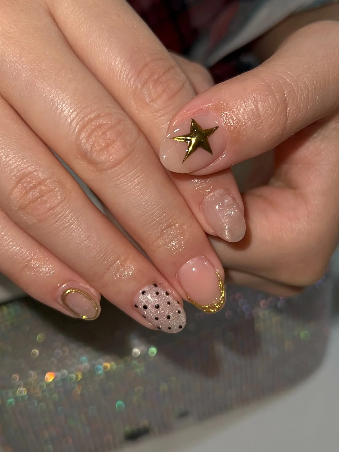 Short nude nails with gold star and black dots