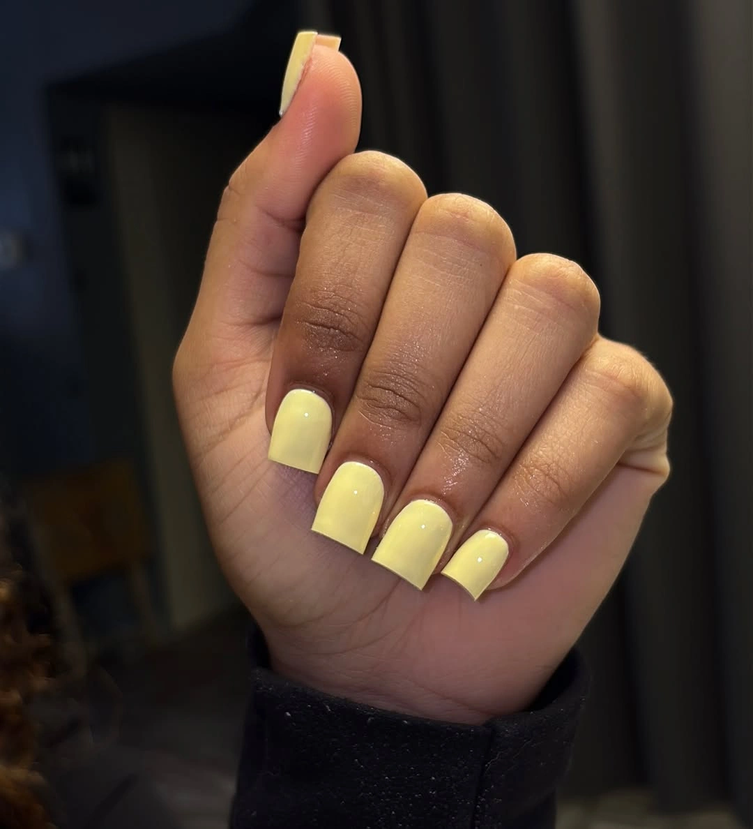 Square nails with pale butter yellow glossy polish