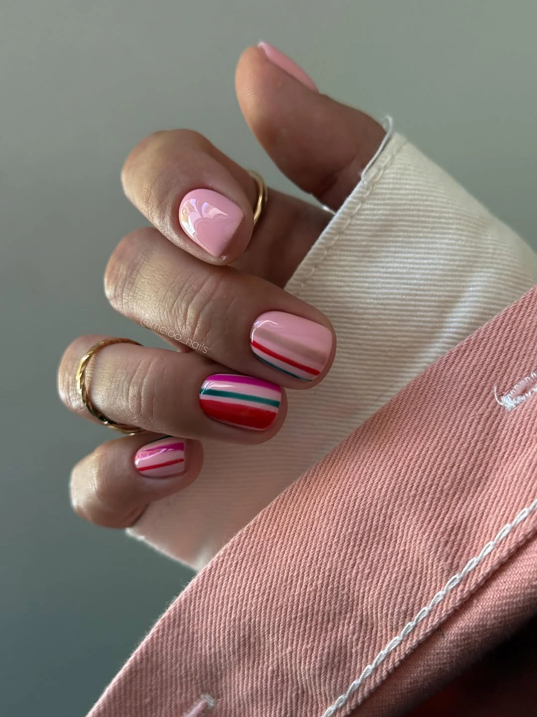 Short pink nails with red teal and white stripes