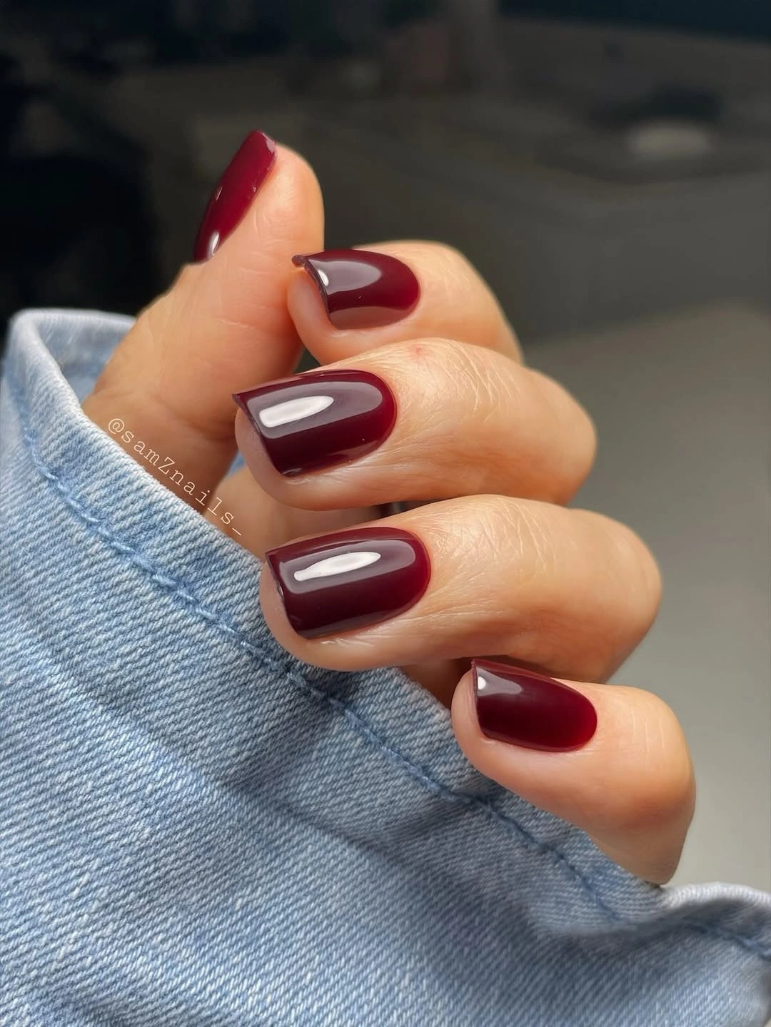 Short rounded-square nails with glossy wine red polish