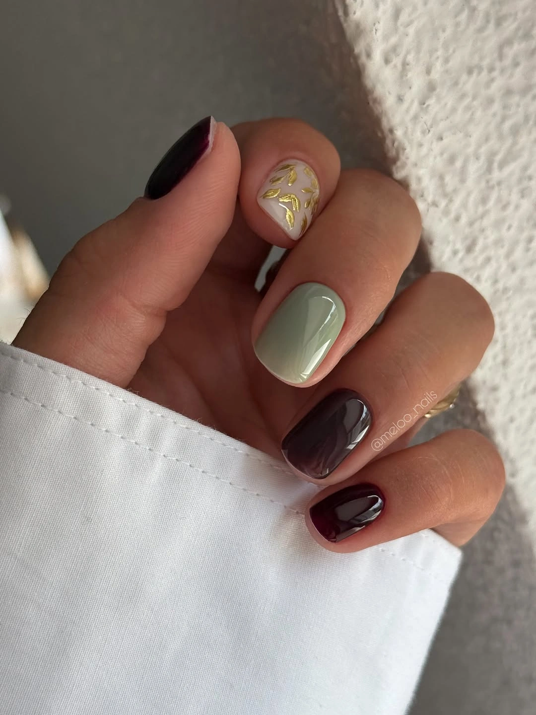Short nails in burgundy, sage green and cream