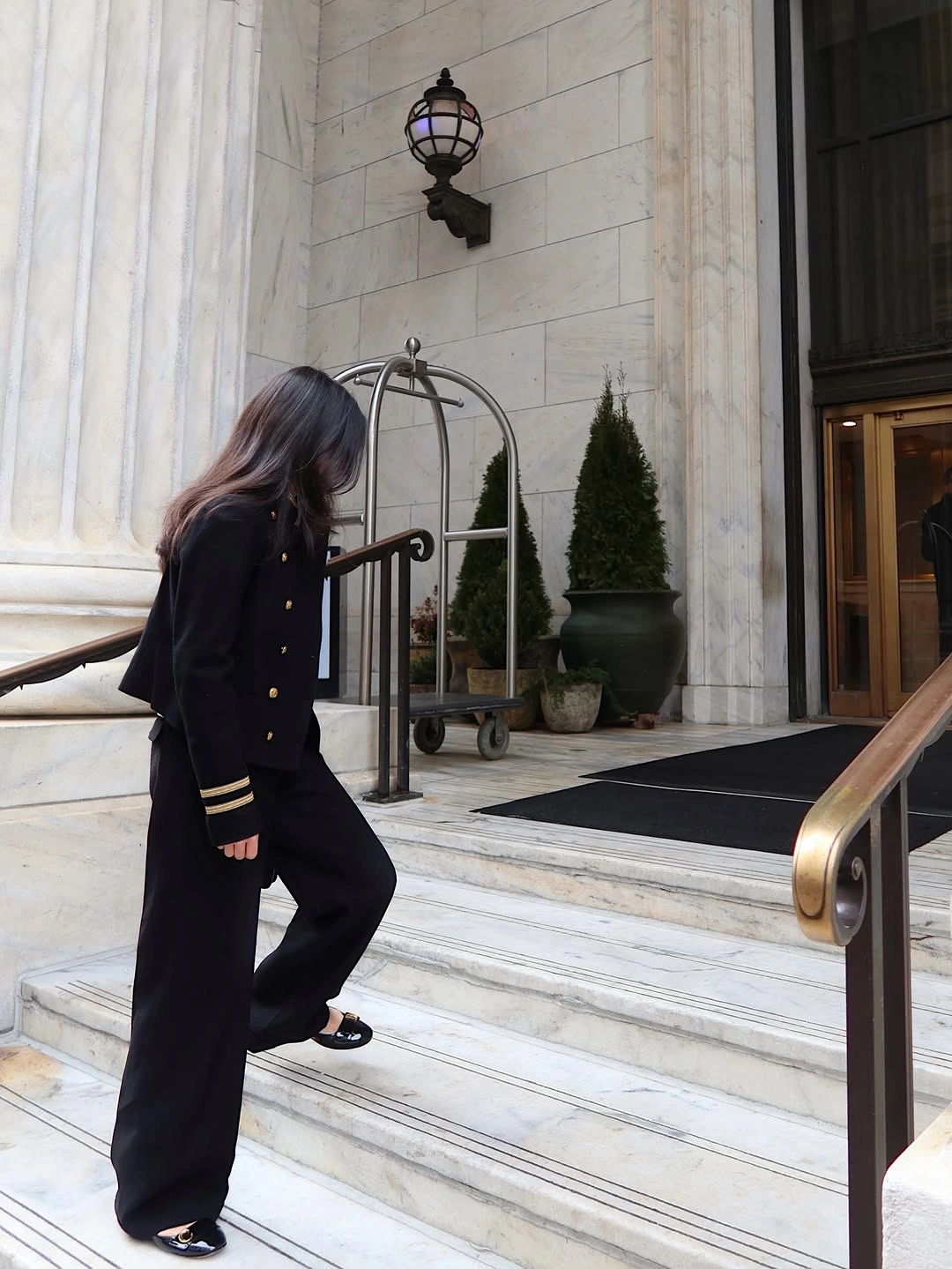 Black cropped gold-button jacket with black flared pants