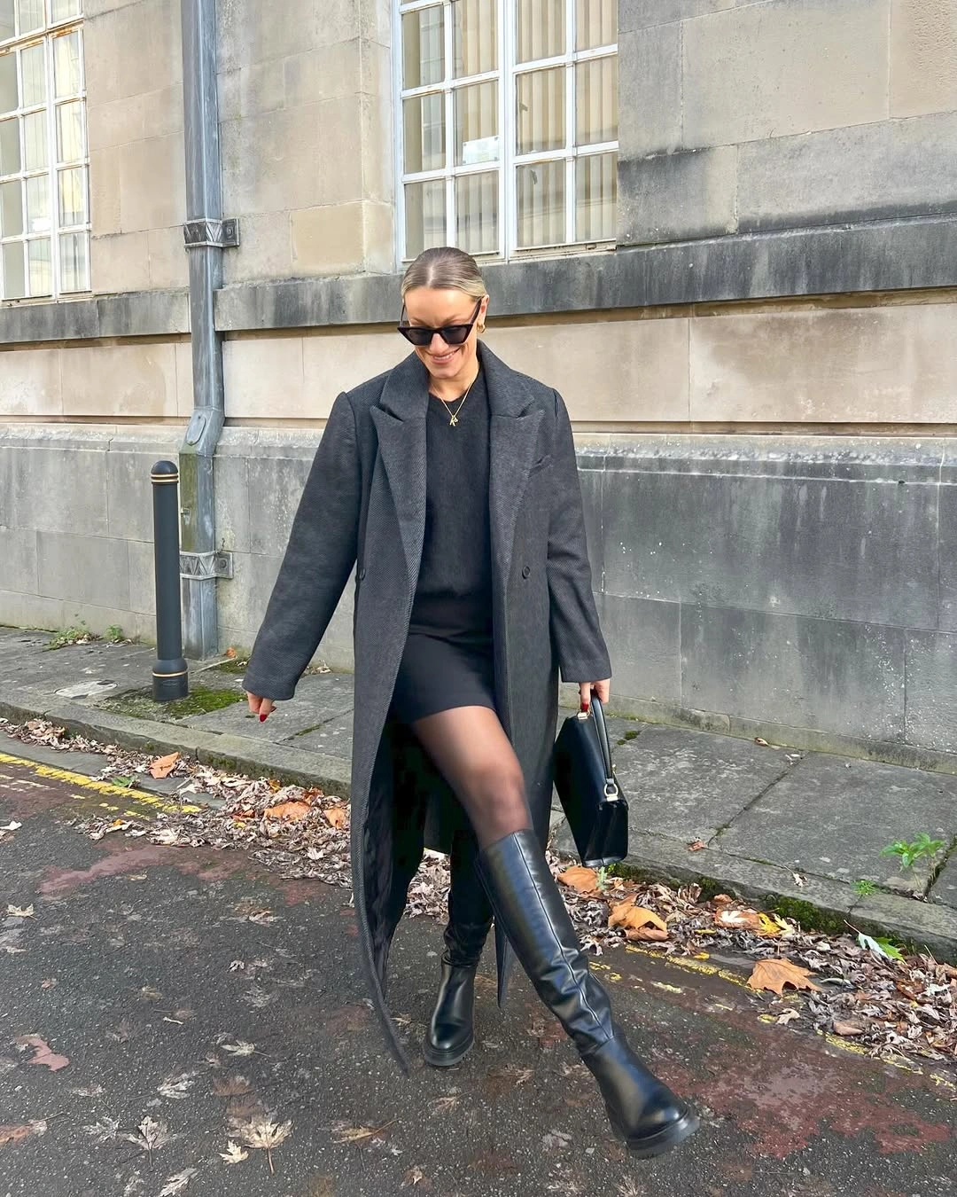 Dark gray long coat with sheer tights and tall boots