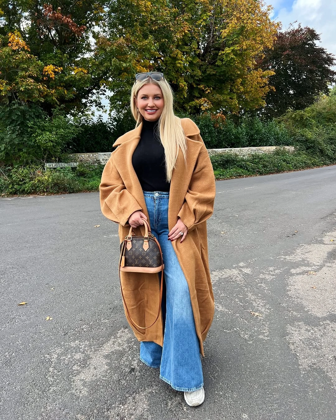 Camel long coat with wide jeans and white sneakers