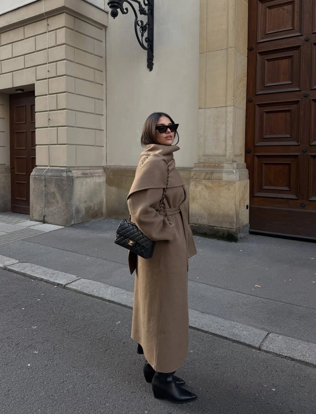 Taupe long coat with black bag and pointed ankle boots