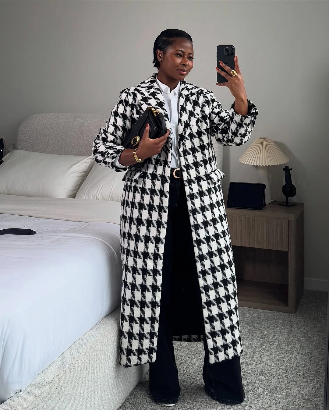 Black-and-white houndstooth coat with white shirt and wide trousers