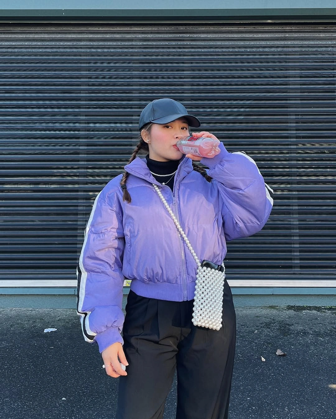 Lilac cropped puffer with black cap, trousers and white beaded bag