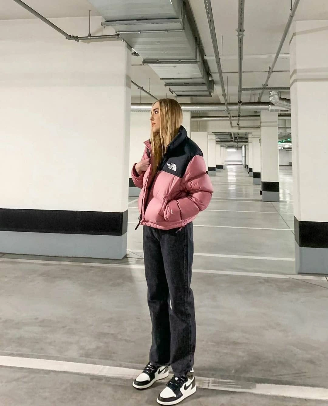 Pink and black colorblock puffer with wide jeans and high-top sneakers