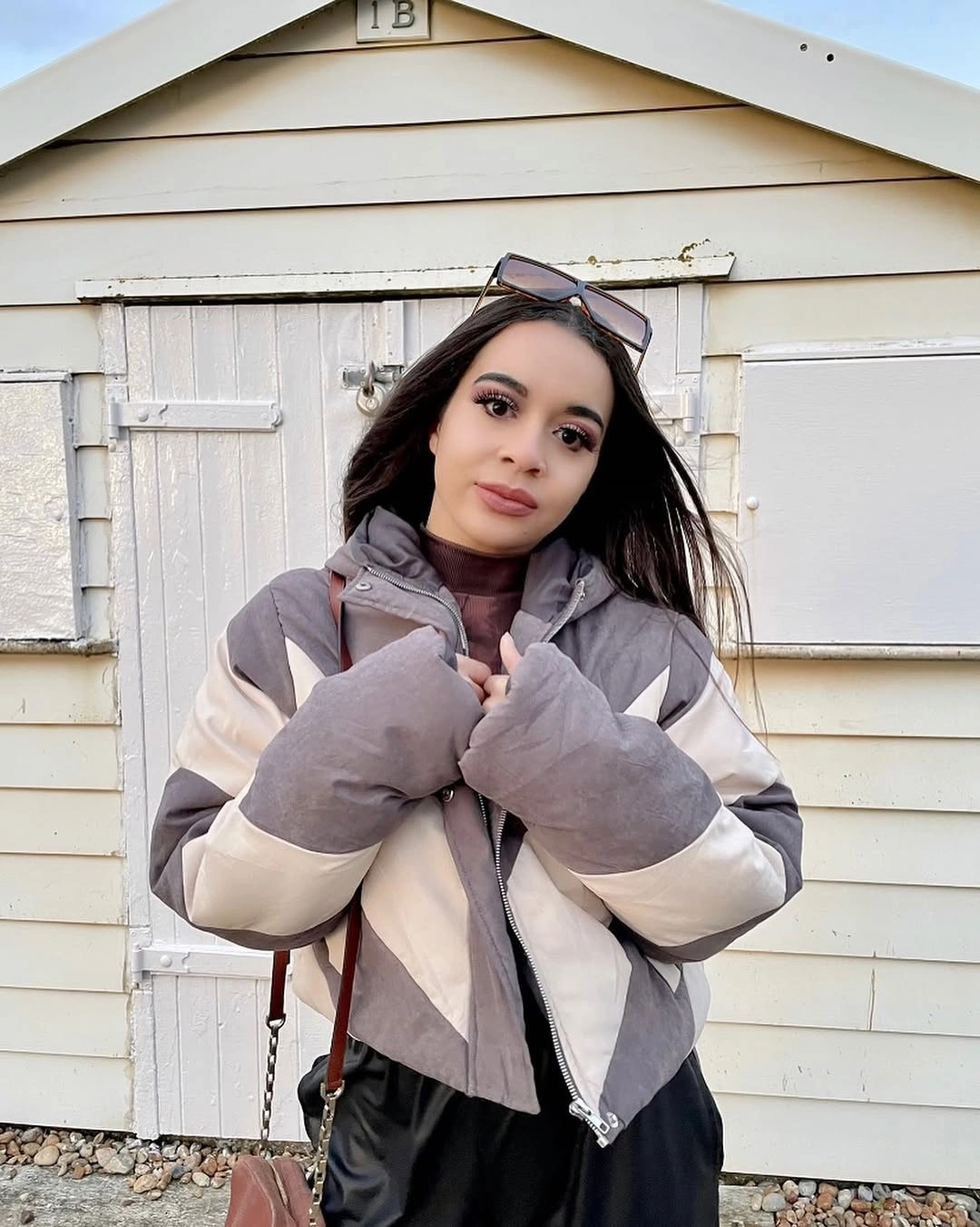 Light gray and cream puffer with burgundy top and black bottoms