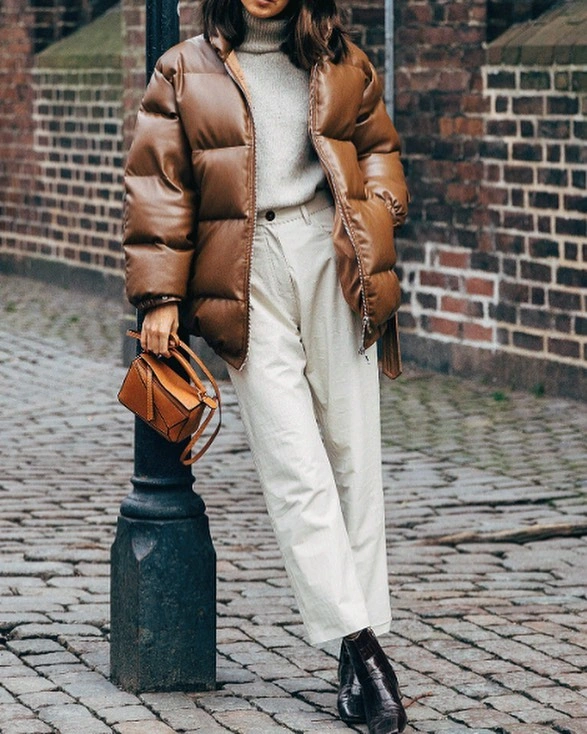 Brown cropped puffer with cream turtleneck, white trousers and black boots