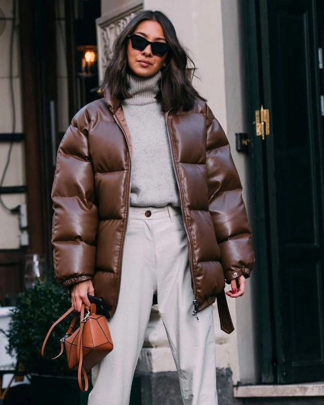 Glossy brown cropped puffer with gray turtleneck and wide cream trousers