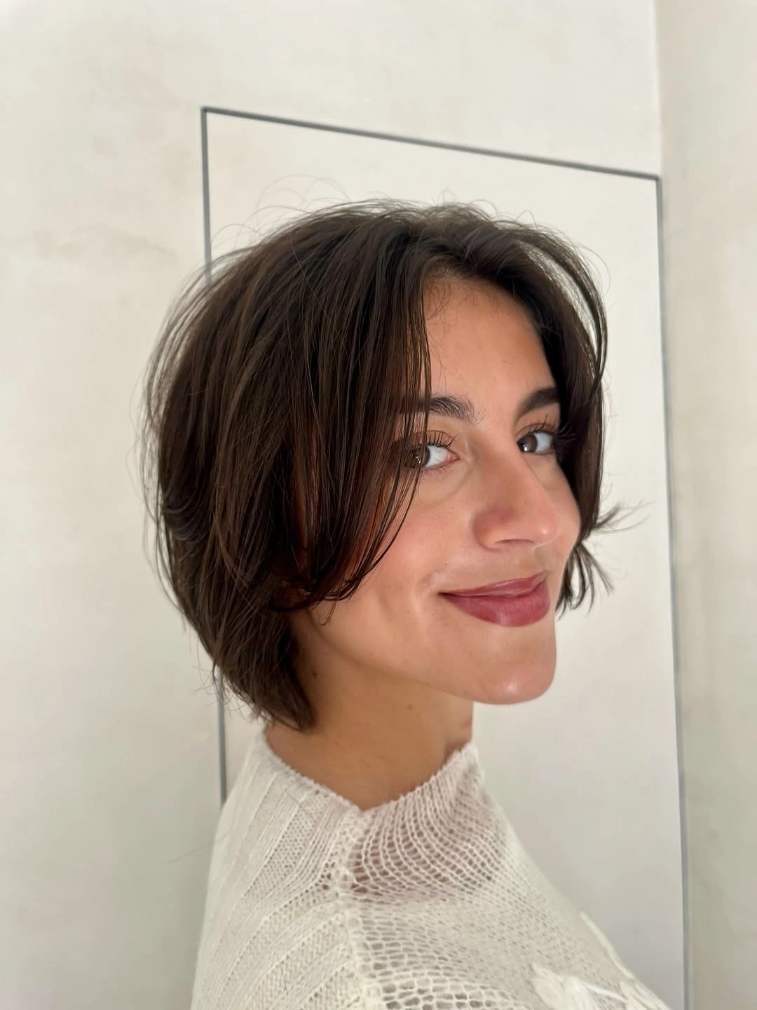 Short brunette bob with curved cheek-length front pieces