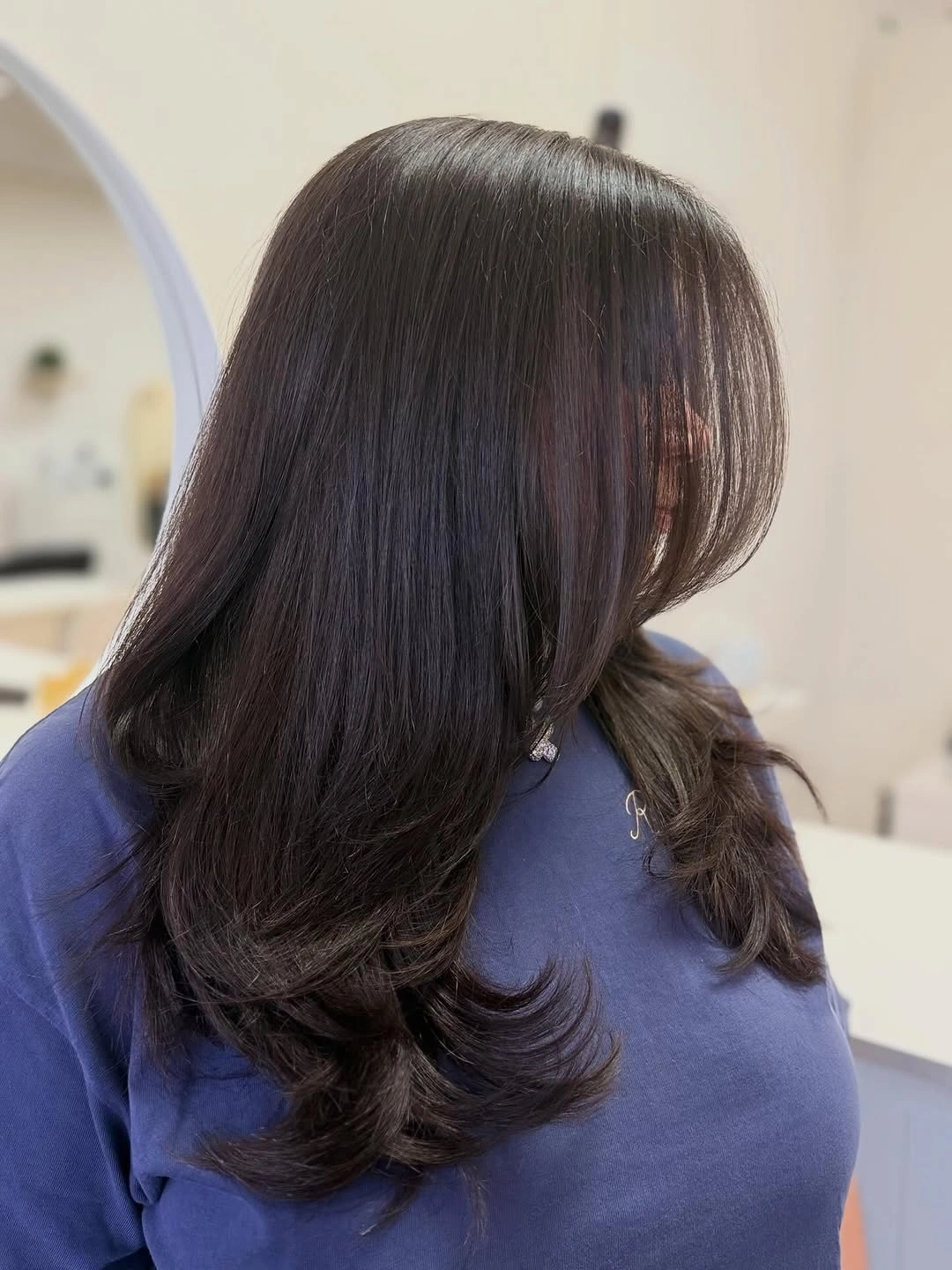 Long dark brunette haircut with curled lower layers