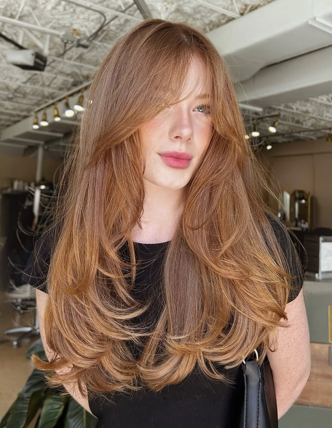 Very long copper hair with face-framing layers and curved ends