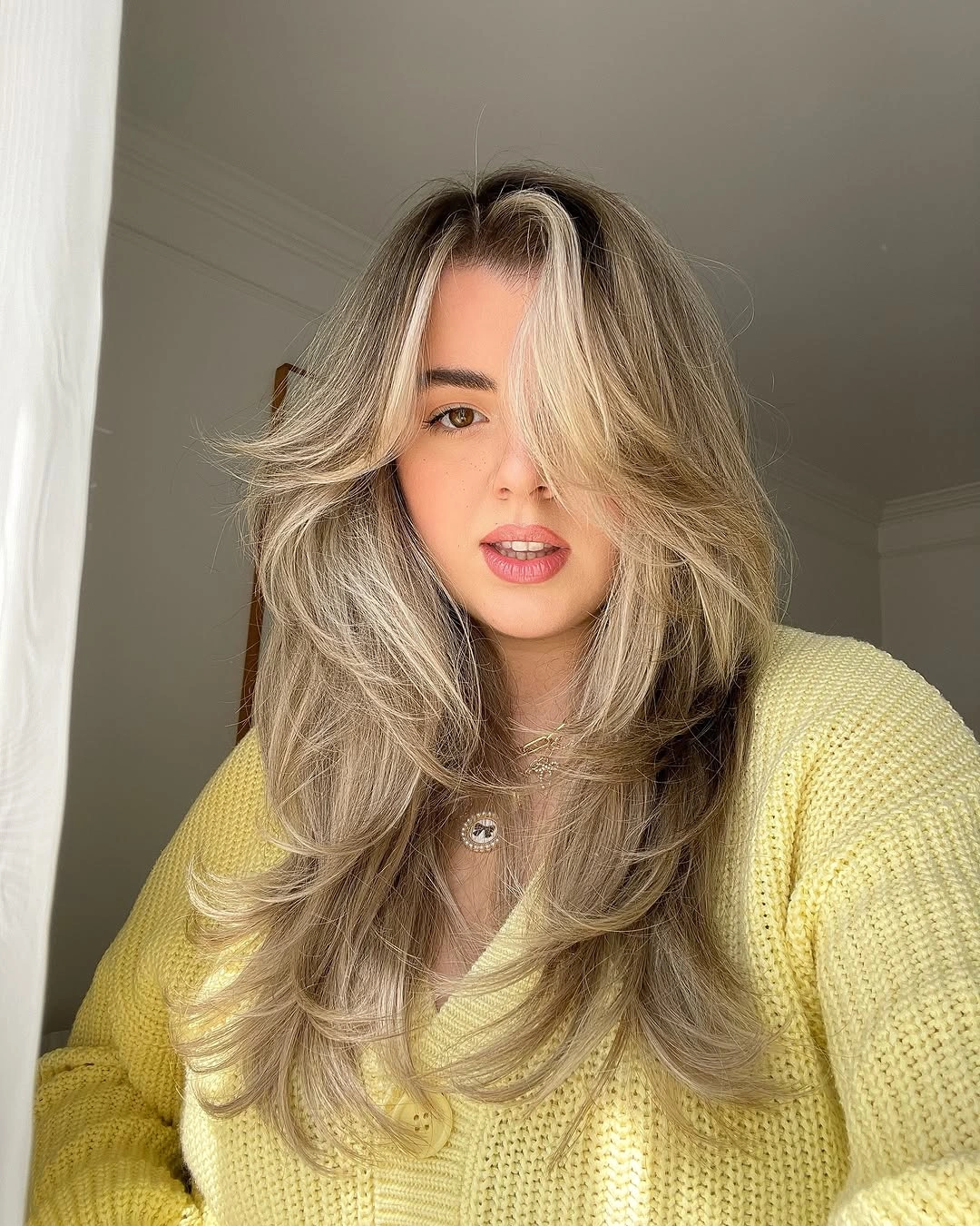 Long ash blonde hair with curtain fringe and separated layers