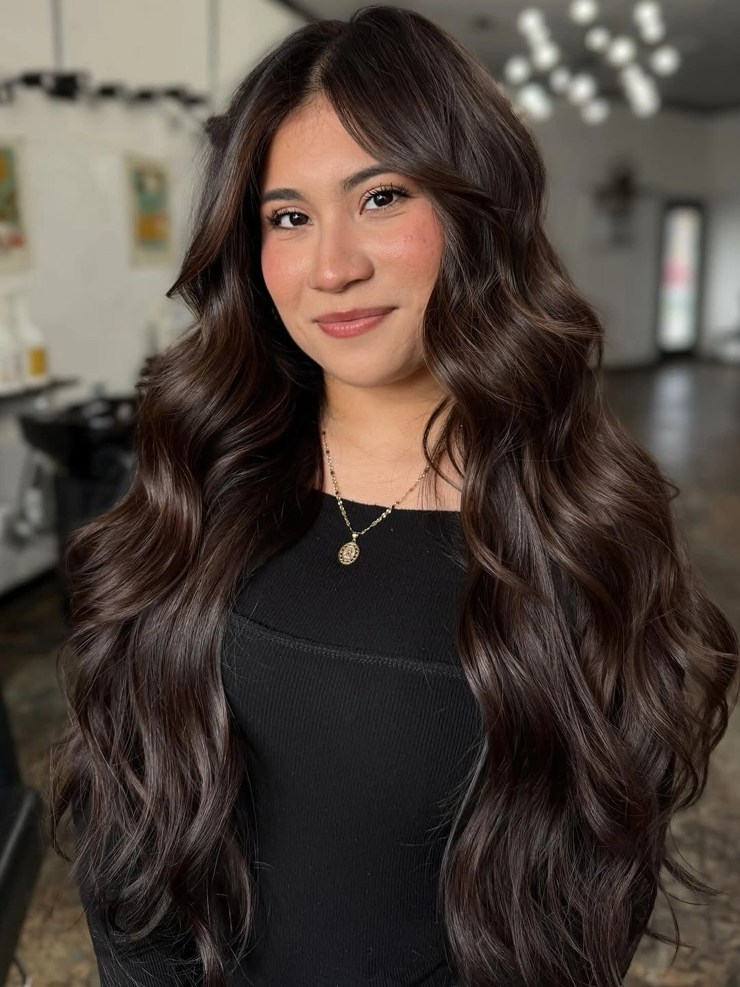 Very long deep brunette hair with center part and soft waves
