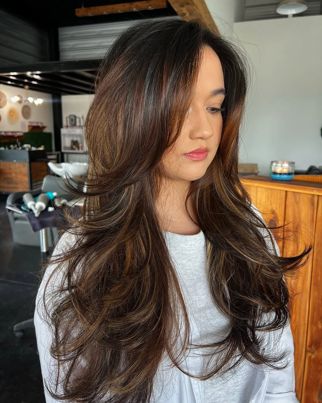 Long rich brunette hair with sweeping front and feathered layers