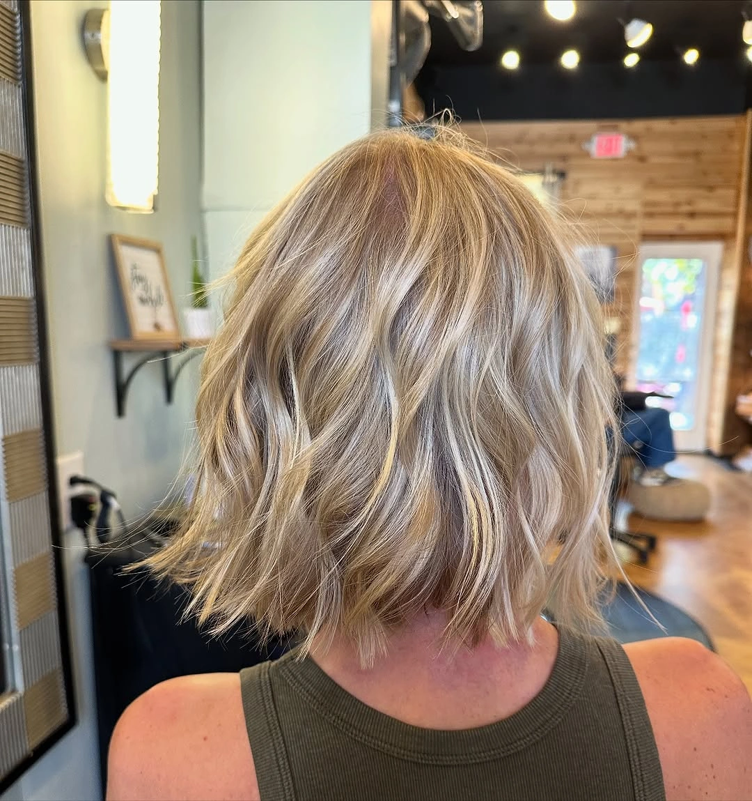 Rear view of short blonde bob with uneven wavy ends
