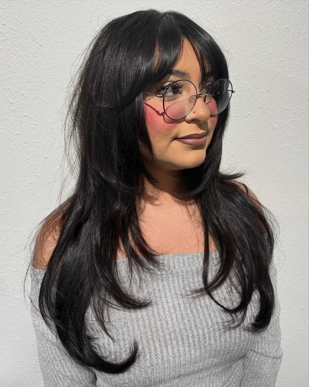 Very long near-black hair with center-parted face-framing layers