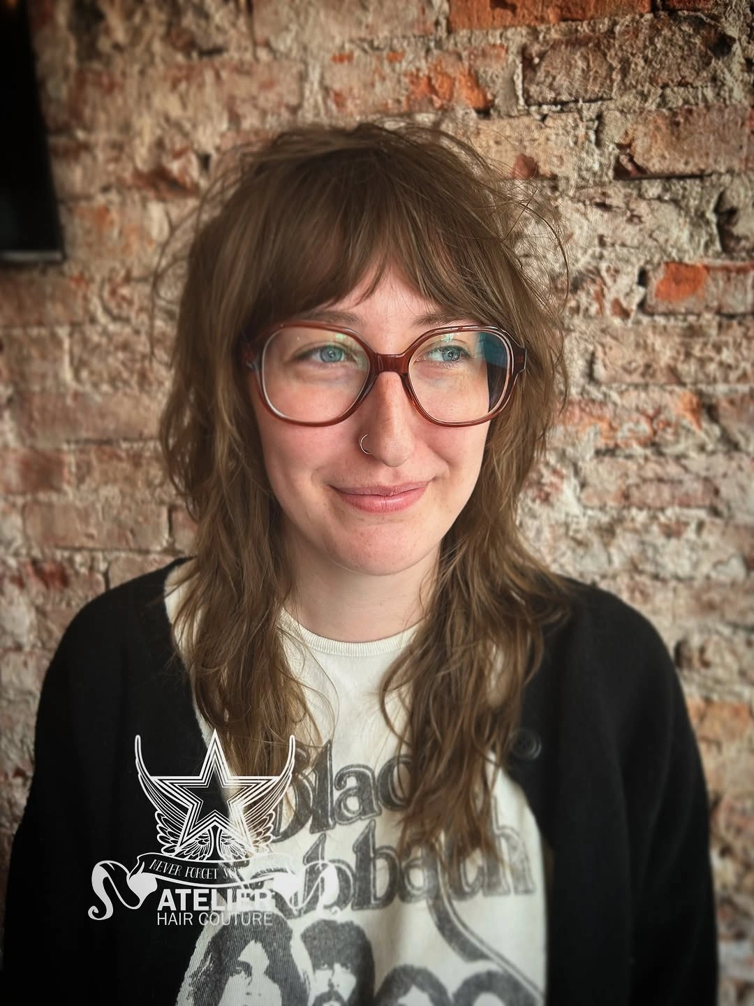 Medium brown layered haircut with wispy fringe and loose waves