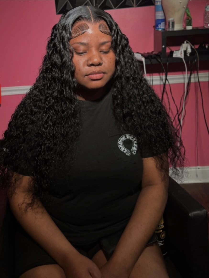 Long dark curls with center part and sculpted hairline