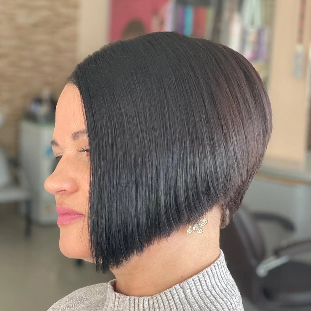 Rounded dark brunette bob with heavy side swept fringe