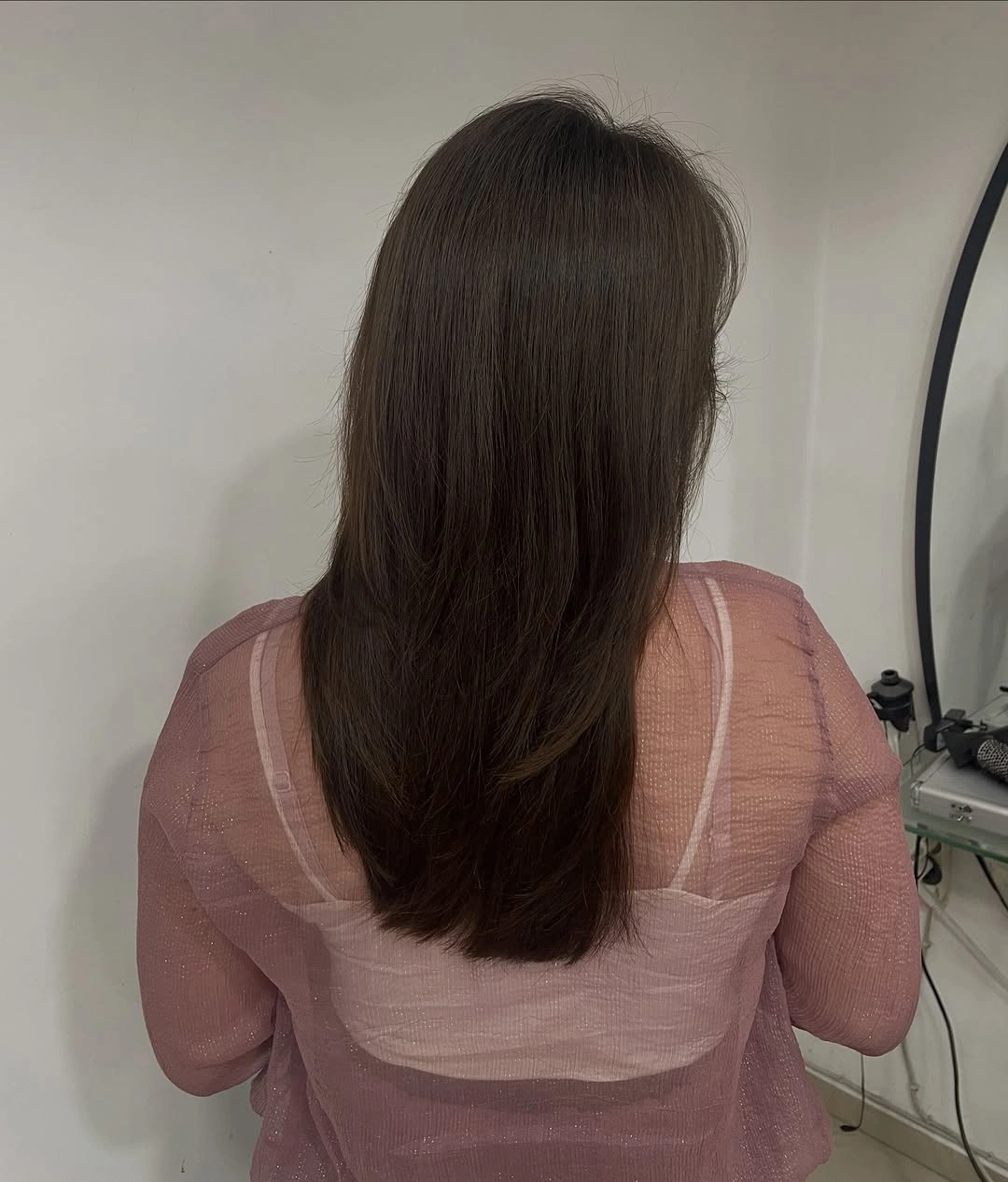 Warm brown mid-length layered cut with tapered lower ends