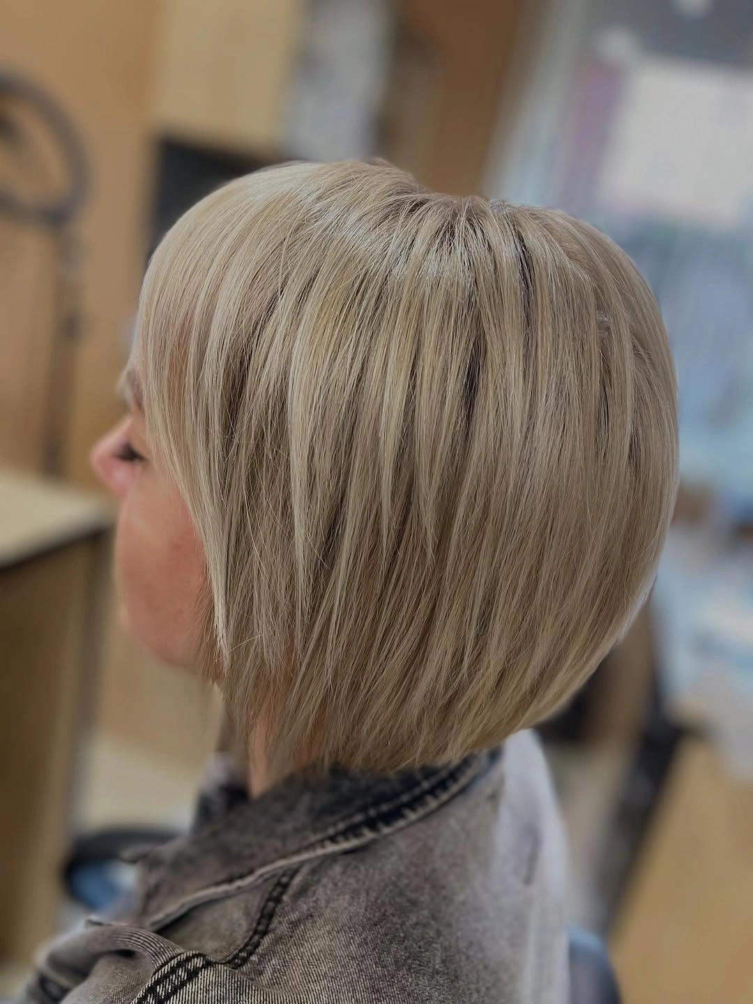 Side view of angled blonde bob with longer front pieces
