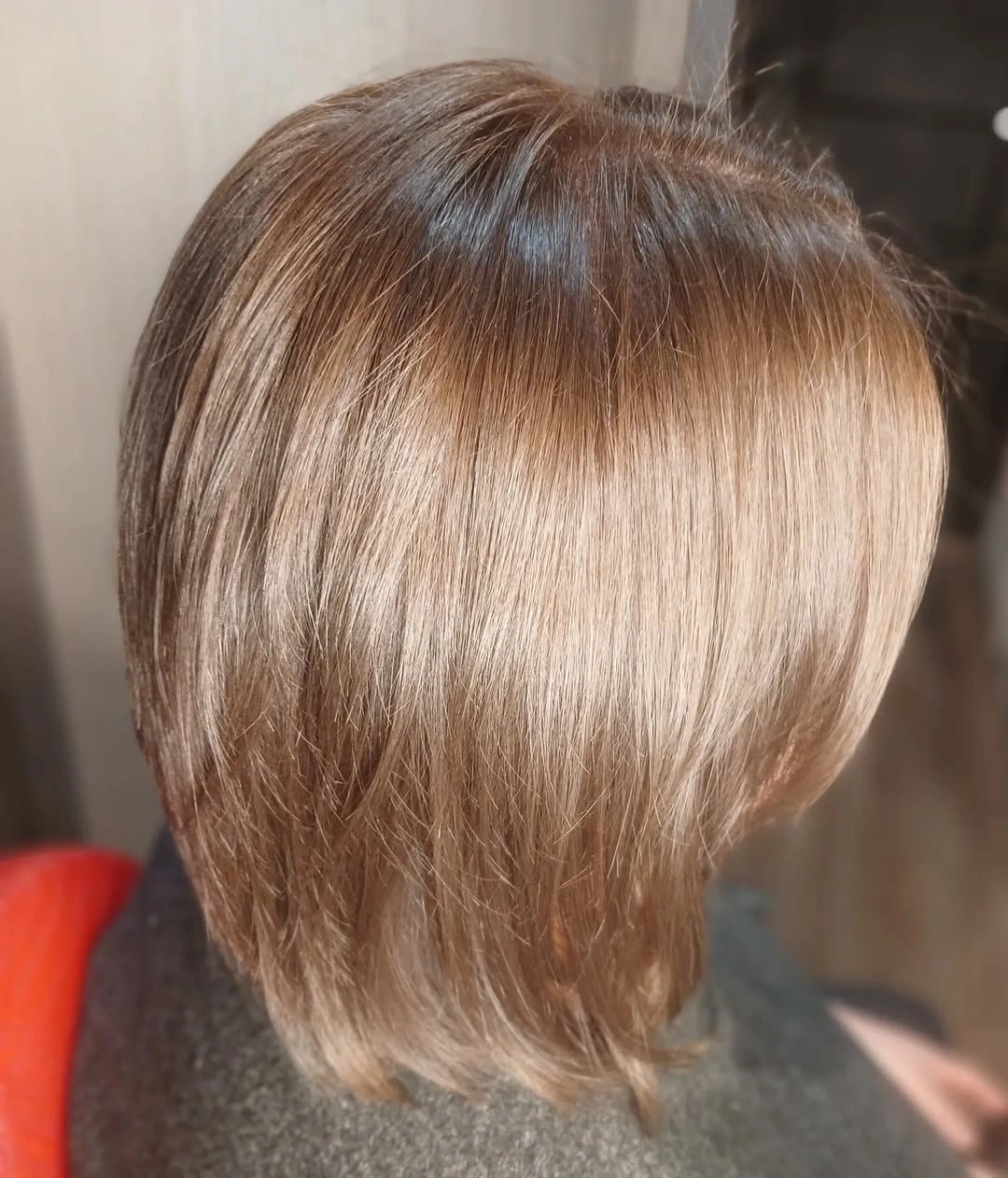 Angled view of light blonde bob with feathered ends