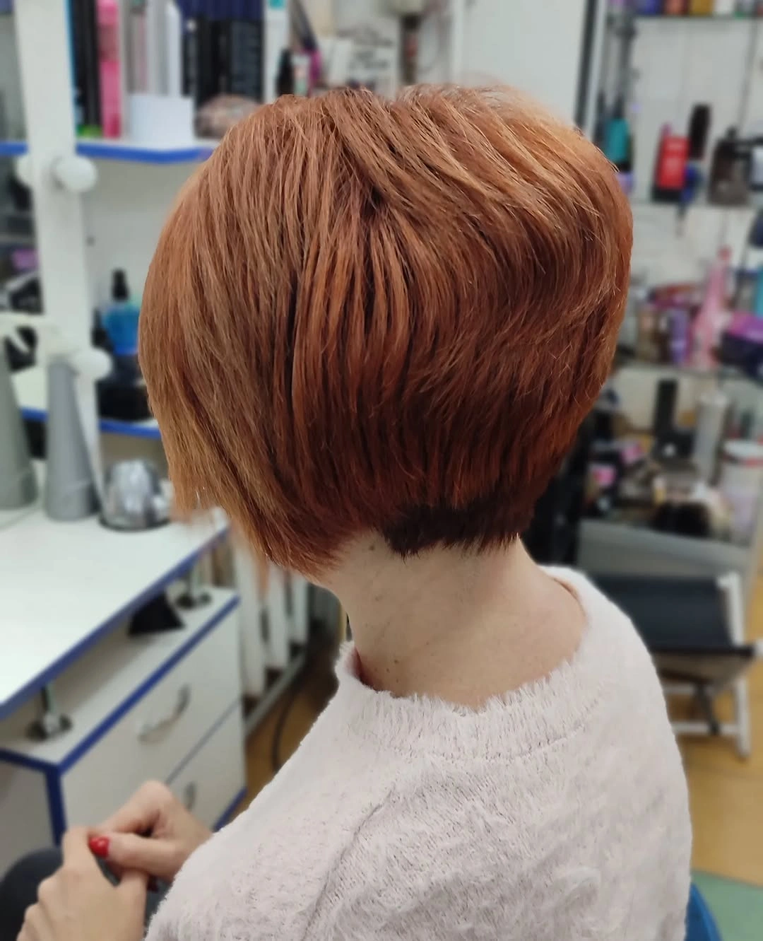 Side back view of copper stacked short haircut