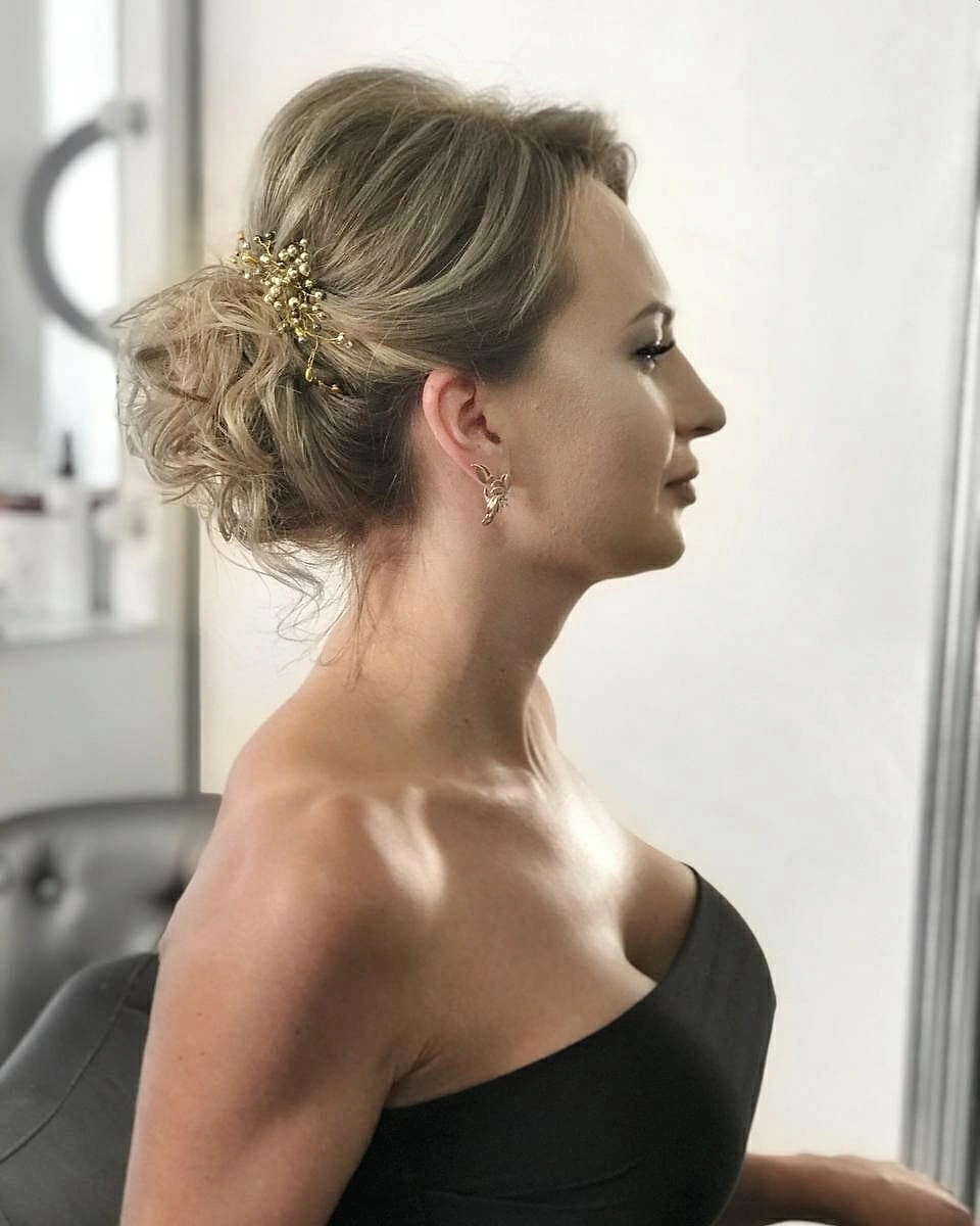 Side view of blonde pinned updo with front pieces