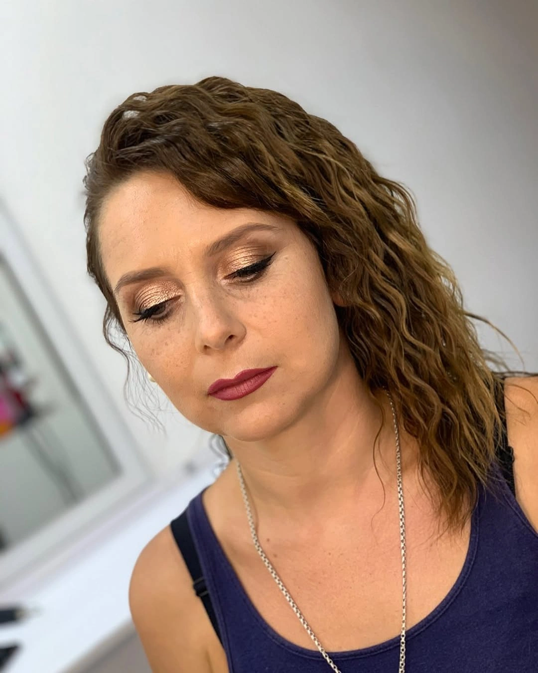 Front view of brown side swept curly hair