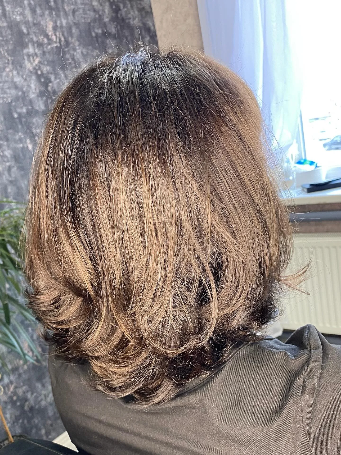 Back view of smooth brown shoulder length hair with flipped ends