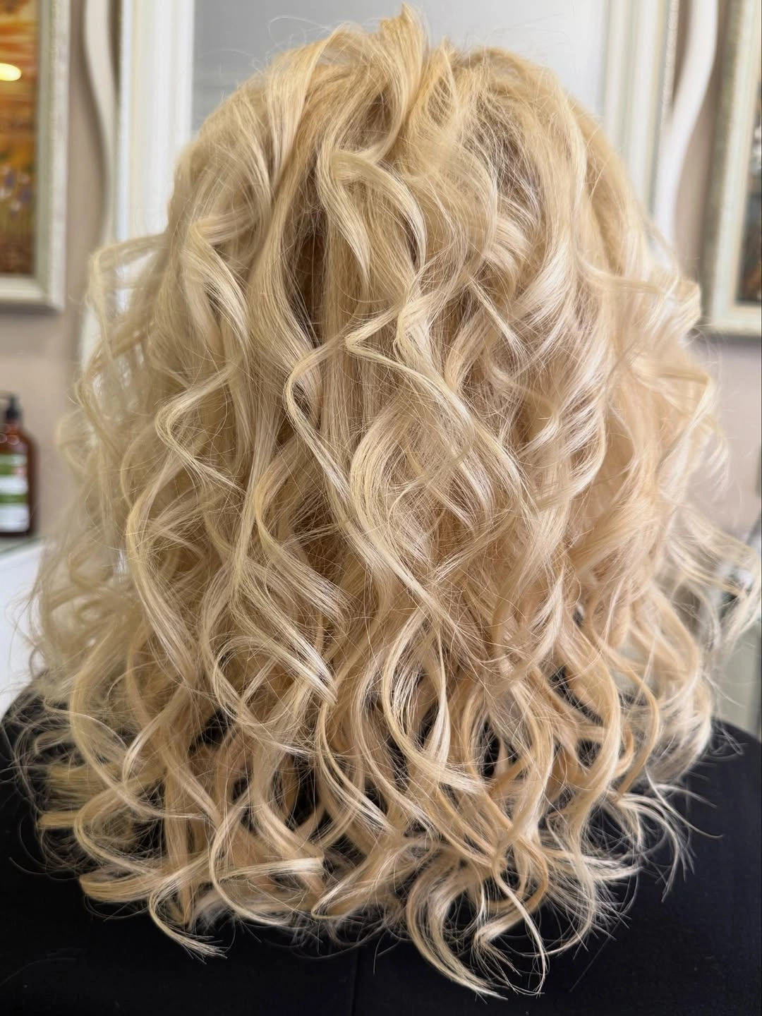 Back view of long blonde curls below the shoulders