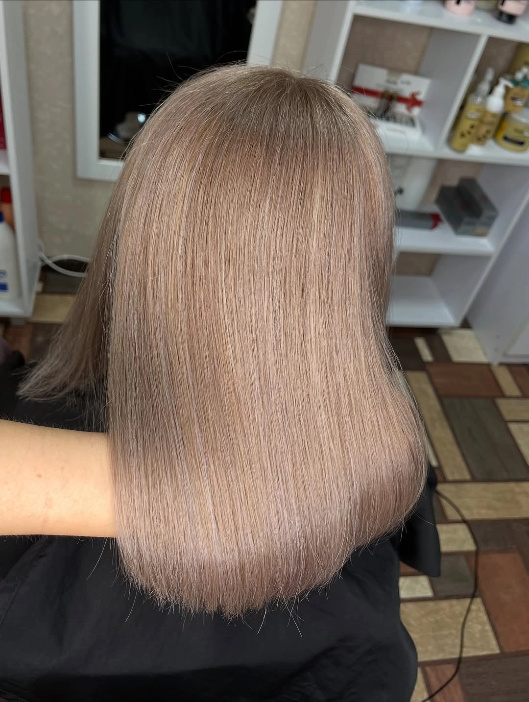 Back view of smooth taupe rounded bob