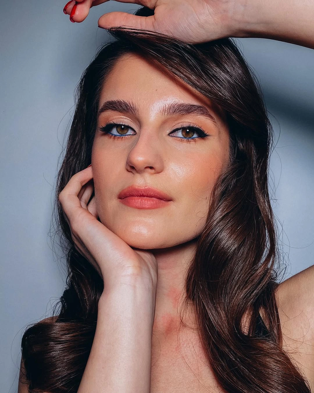 Long brunette side-swept hair with glossy waves