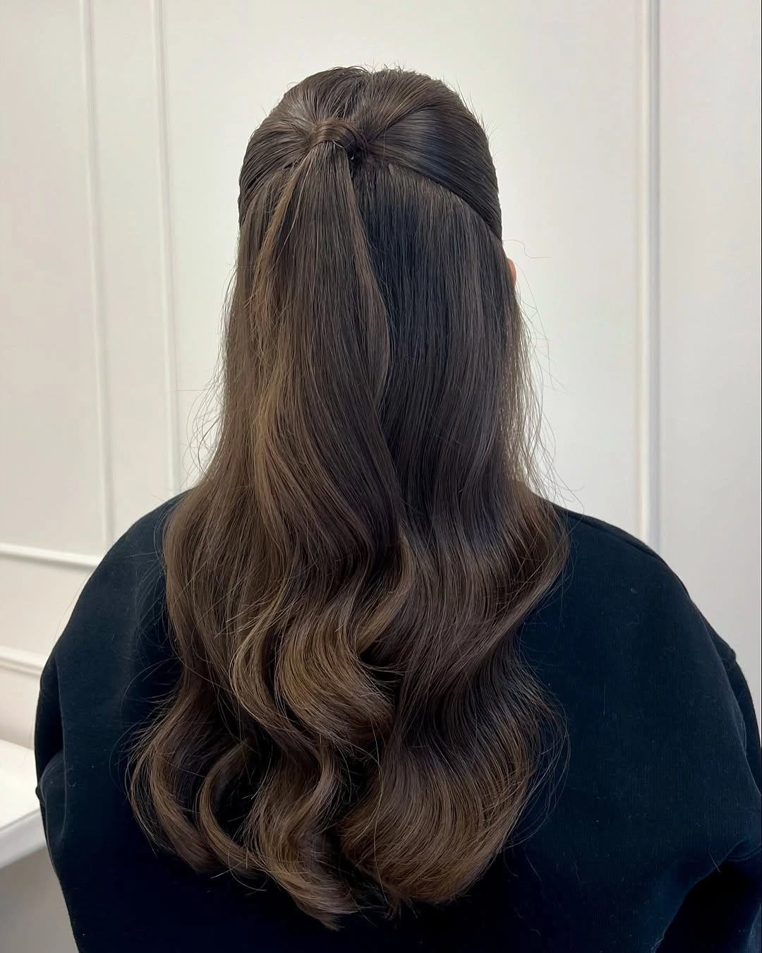 Long dark half-up waves with gathered crown