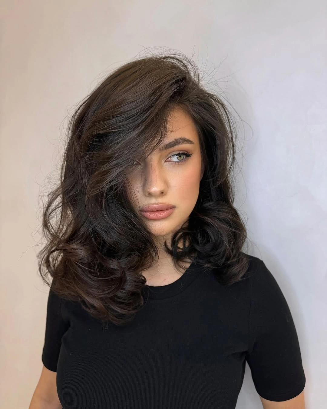 Medium brunette waves with deep side-swept front