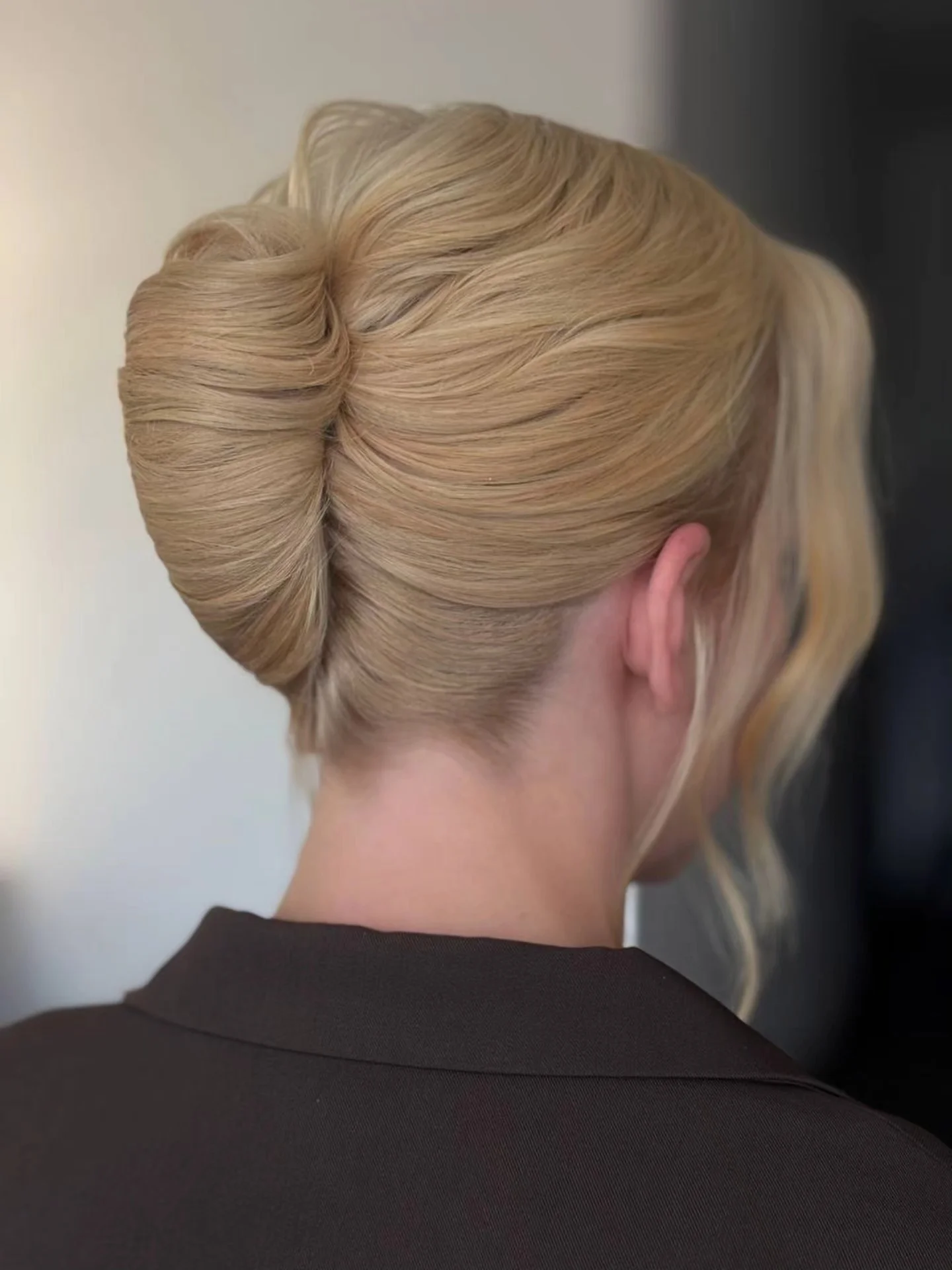 Blonde tucked updo with loose front strand