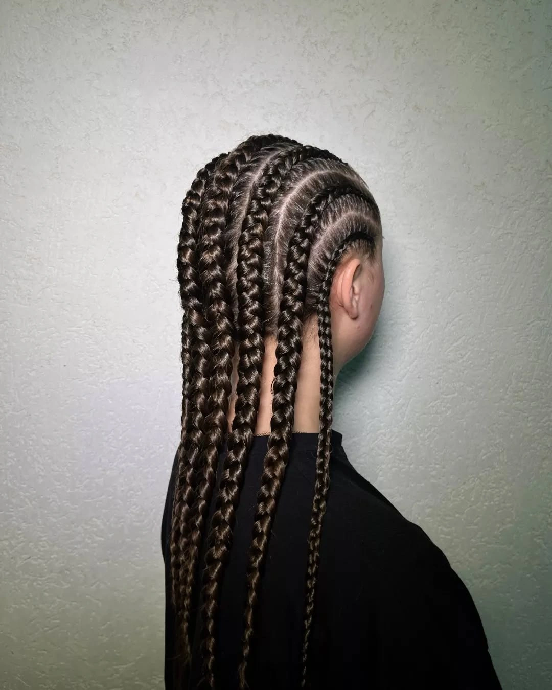 Long dark braids with clean scalp parting