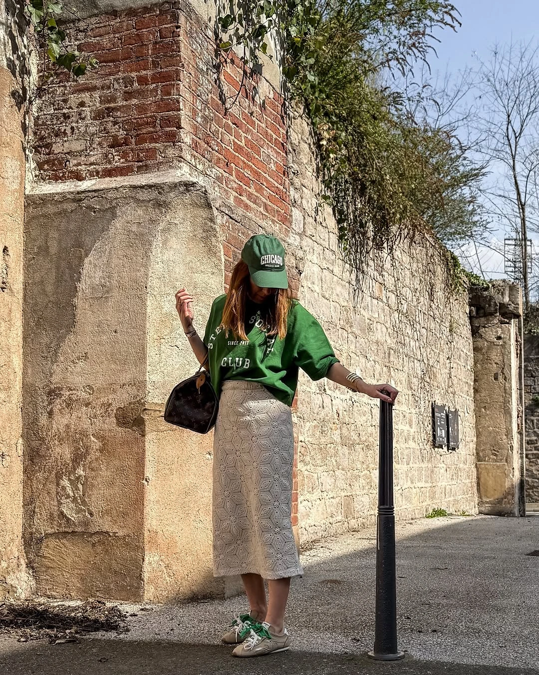 Green tee and cap with pale openwork midi skirt