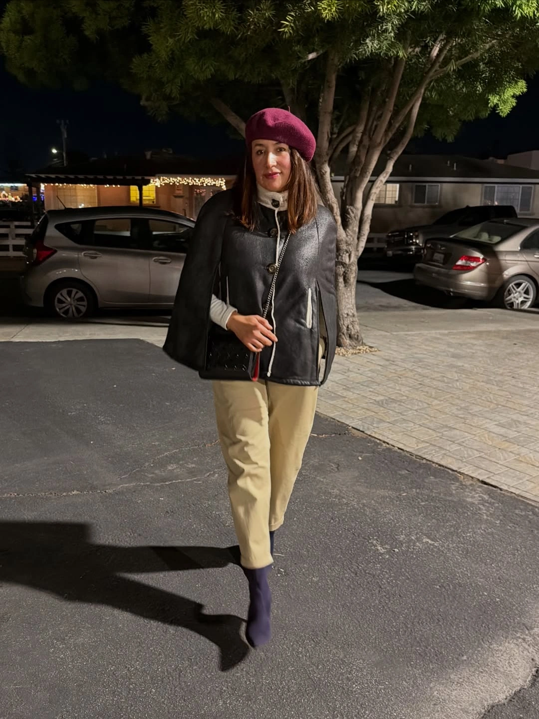 Burgundy beret with black leather-look jacket and beige trousers