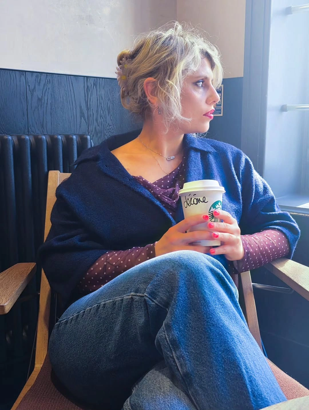 Navy wrap layer over dotted burgundy sleeves and jeans