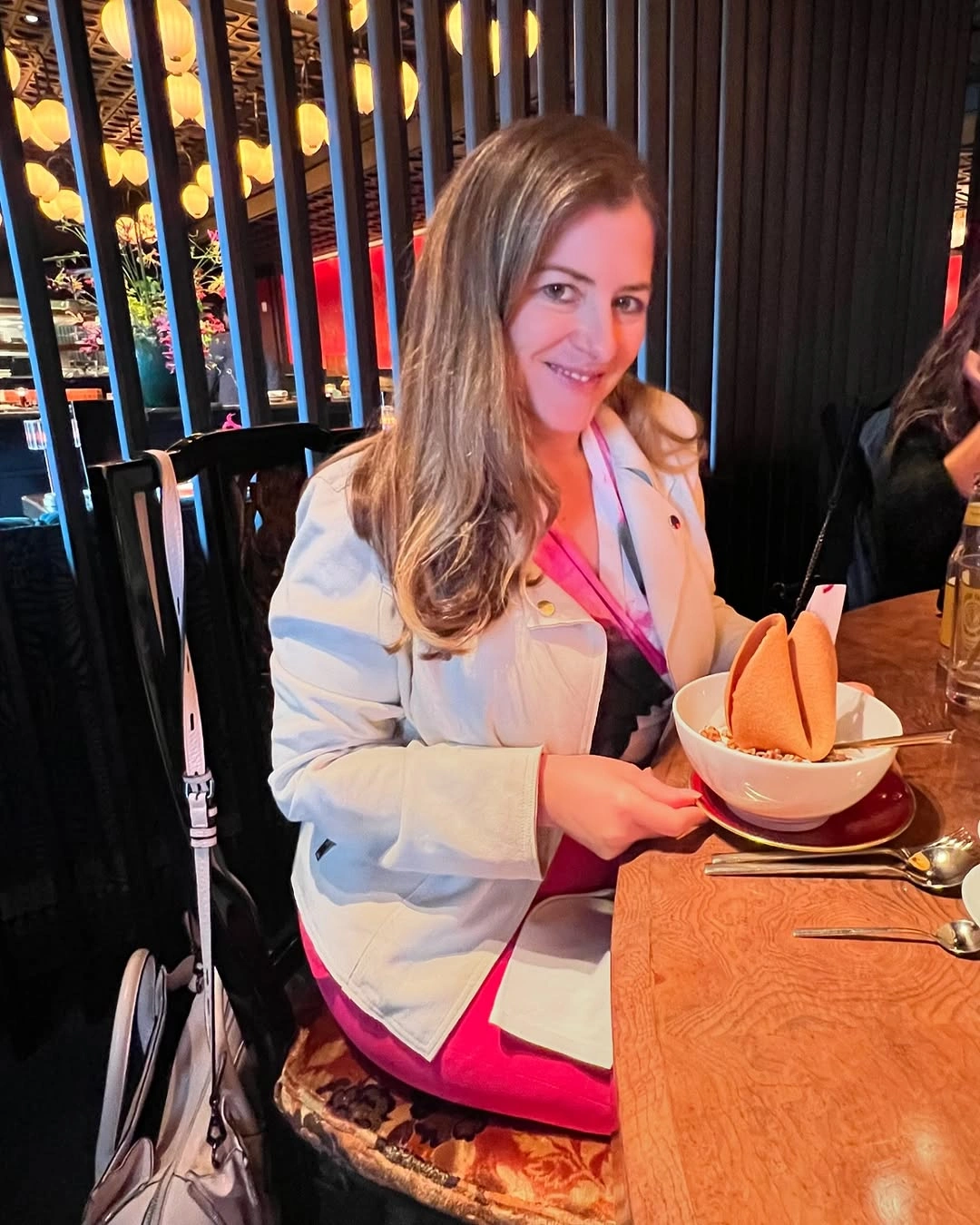 Light jacket over bright pink dress or one-piece